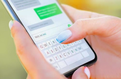 Parent and teen having a calm conversation beside a smartphone; communication and trust